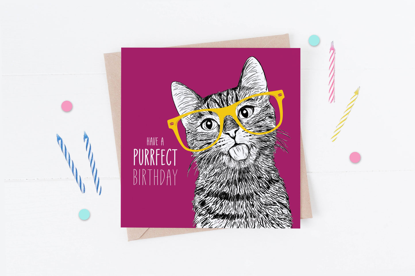 Greeting card with a cat illustration wearing glasses and text 'Have a purrfect birthday' on a pink background.
