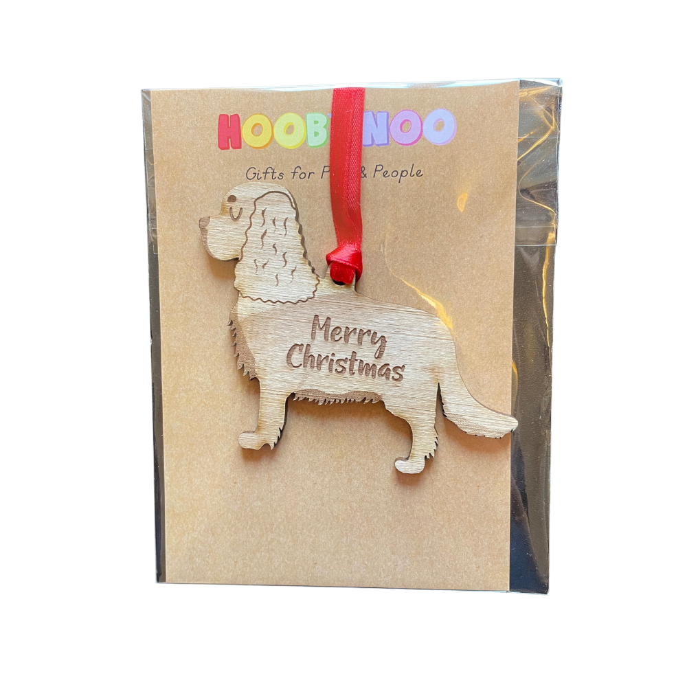 Wooden dog-shaped ornament with 'Merry Christmas' text on a branded card.