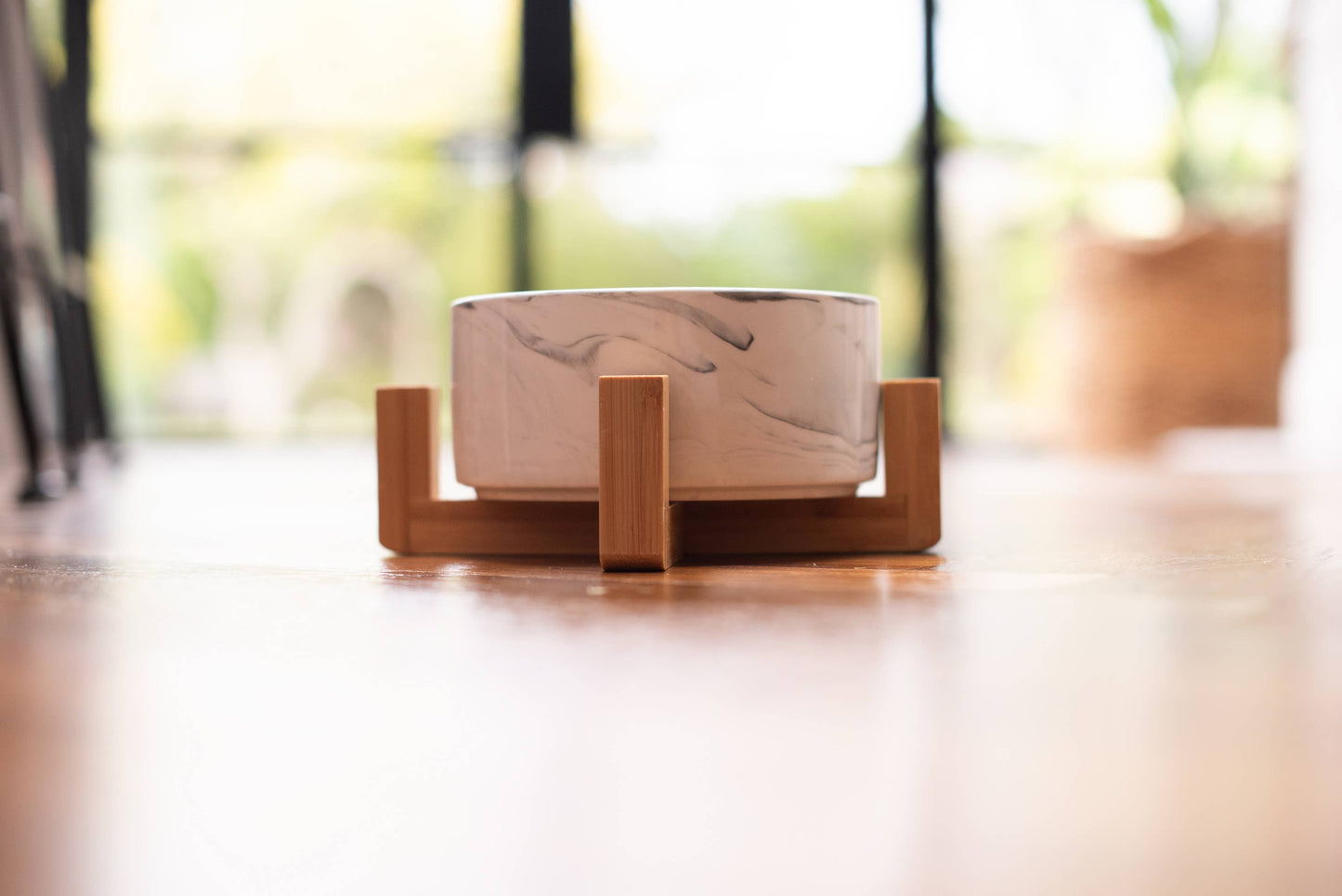 Marble-patterned bowl on a wooden stand with a blurred background