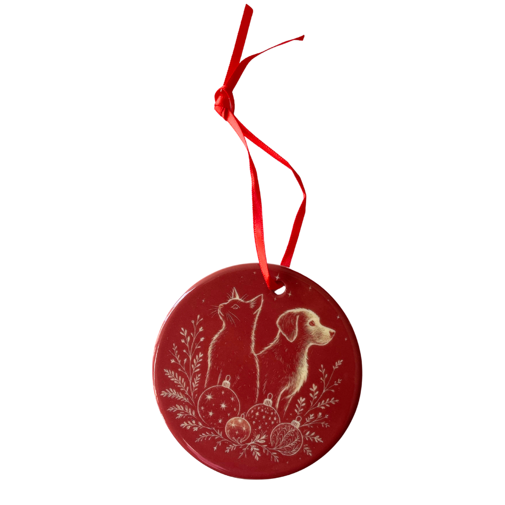 Red Christmas ornament with a cat and dog design on a white background