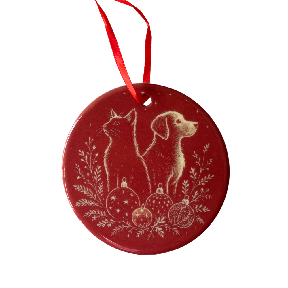 Red Christmas ornament with a dog and cat design on a white background