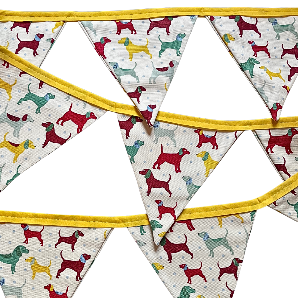 Fabric bunting with a dog pattern material and yellow binding.