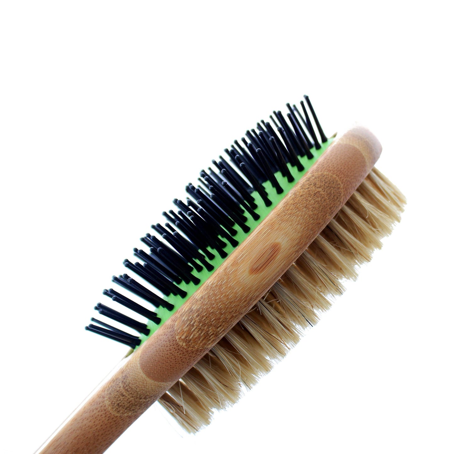 Double-sided brush with black and green bristles on one side and beige bristles on the other, on a white background.