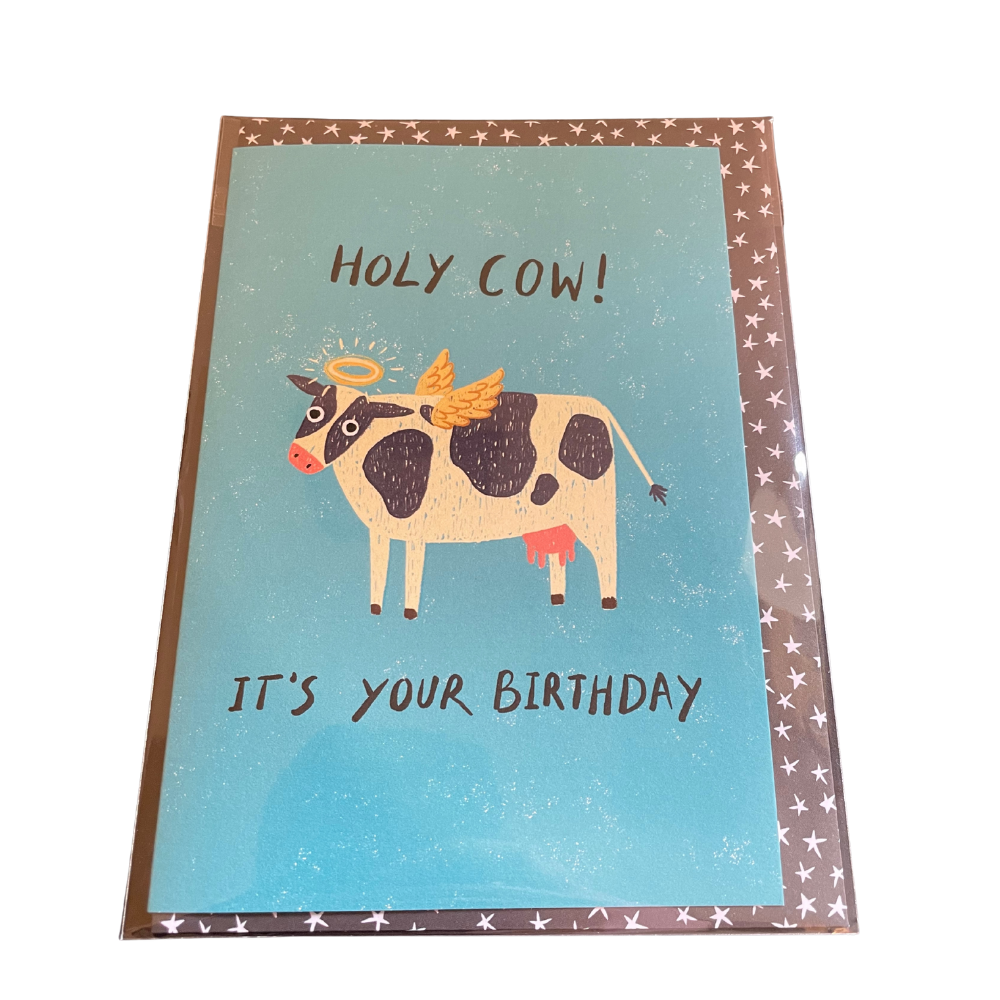 Birthday card with a cow illustration and text on a blue background