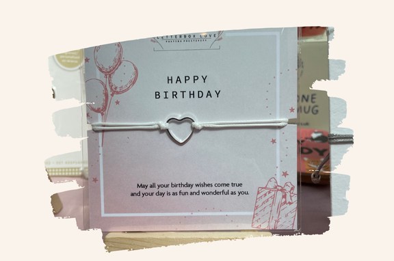 Heart-shaped bracelet on a birthday card with text