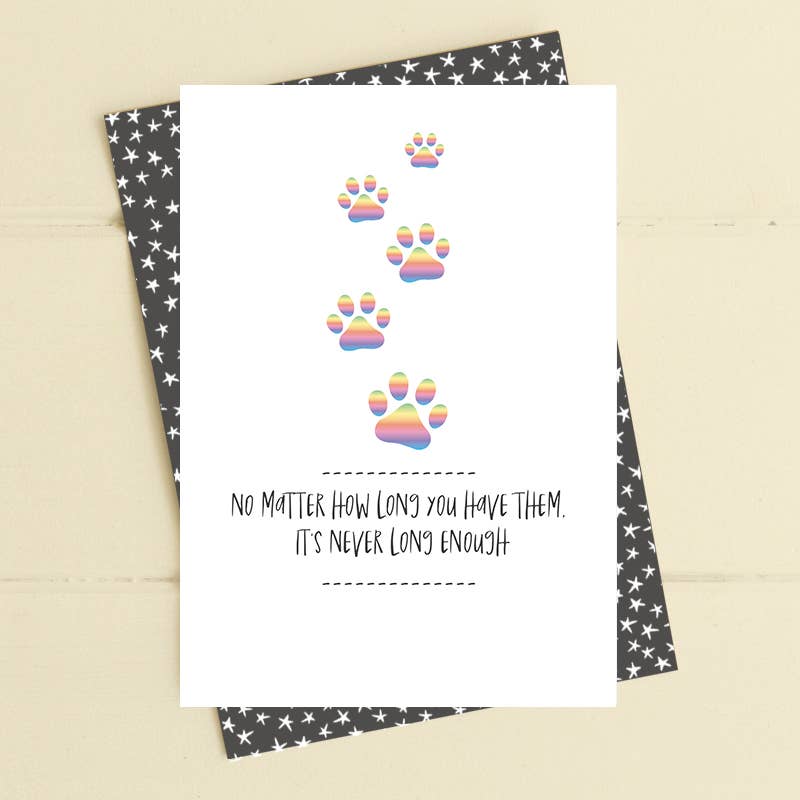 Card with rainbow paw prints and text on a star-patterned envelope