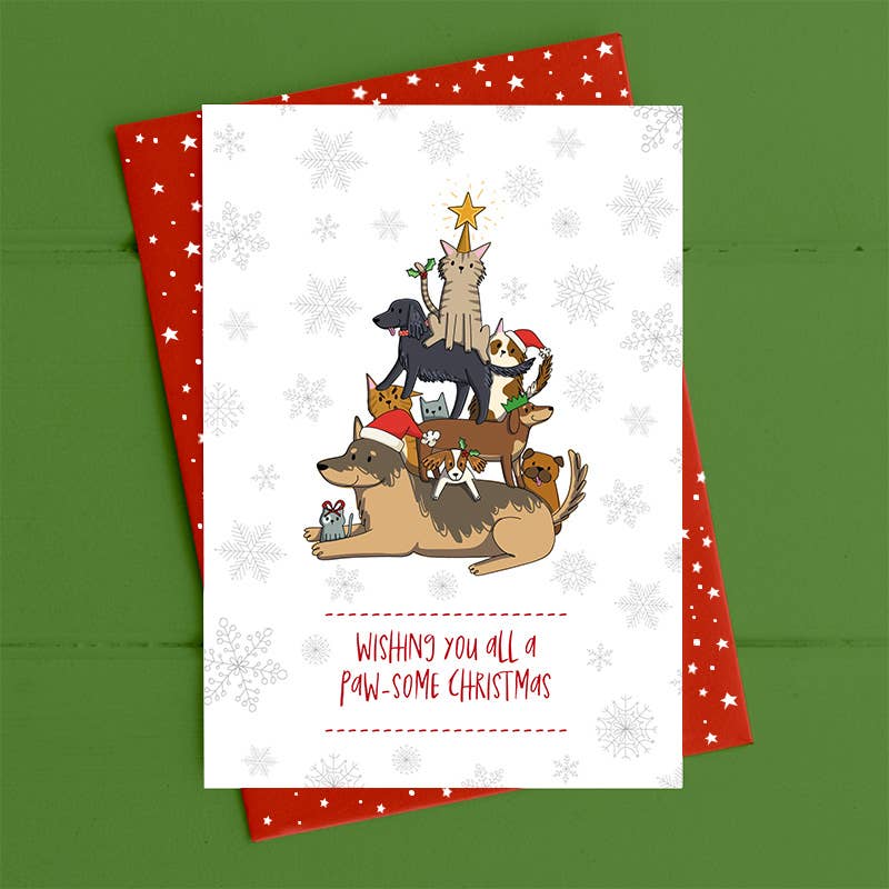 Christmas card with cartoon dogs and cats forming a Christmas tree on a green background