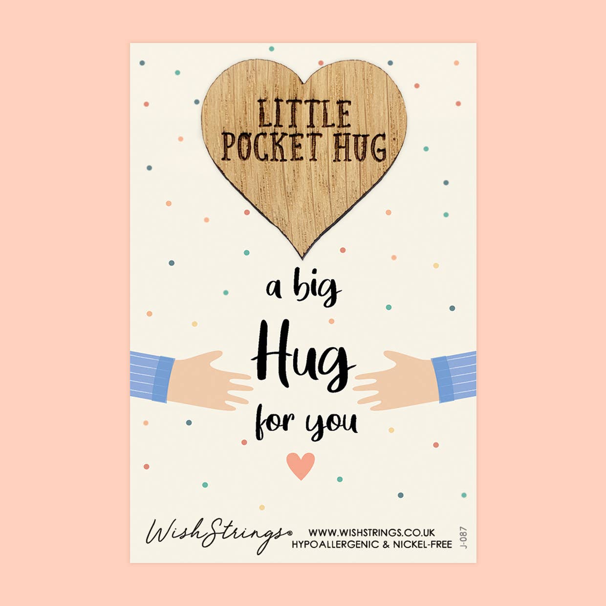 Heart-shaped wooden tag with 'Little Pocket Hug' text, surrounded by cartoon hands and colorful dots on a light pink background.