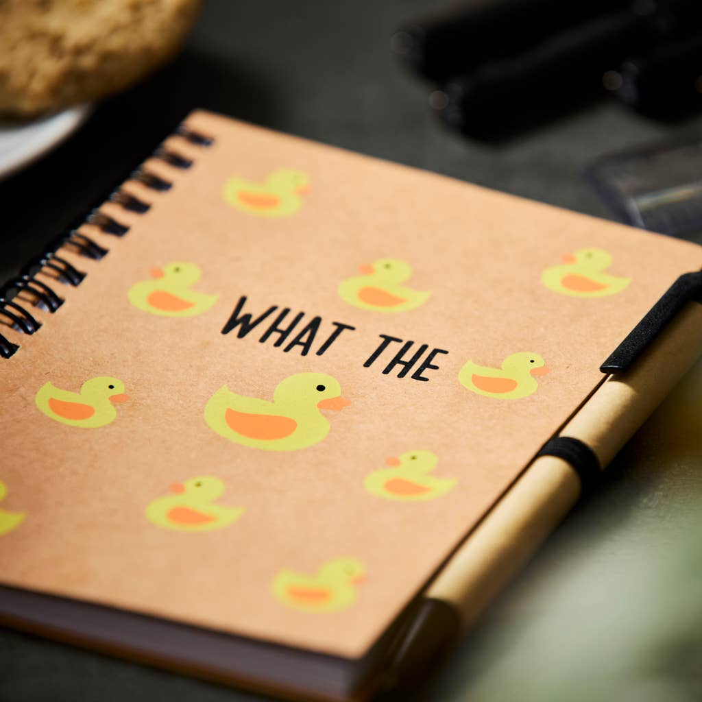 a notepad and pen set saying 'what the duck' with images of yellow ducks printed over the front cover.