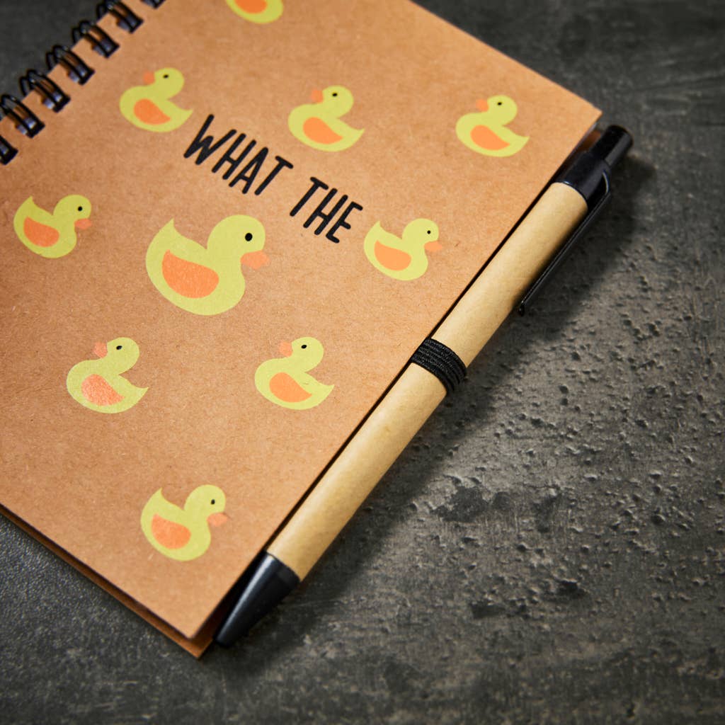 a notepad and pen set saying 'what the duck' with images of yellow ducks printed over the front cover.