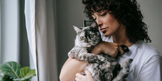 women holding cat in her arms