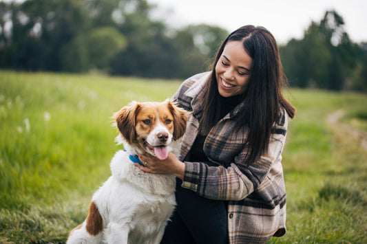 women with her dog in a field