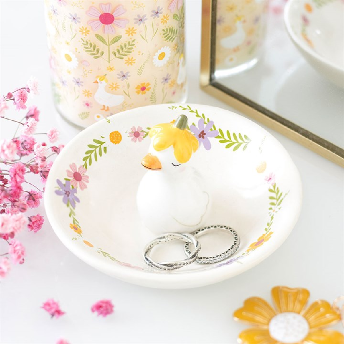 Decorative ring dish with a cartoon duck design on a floral background