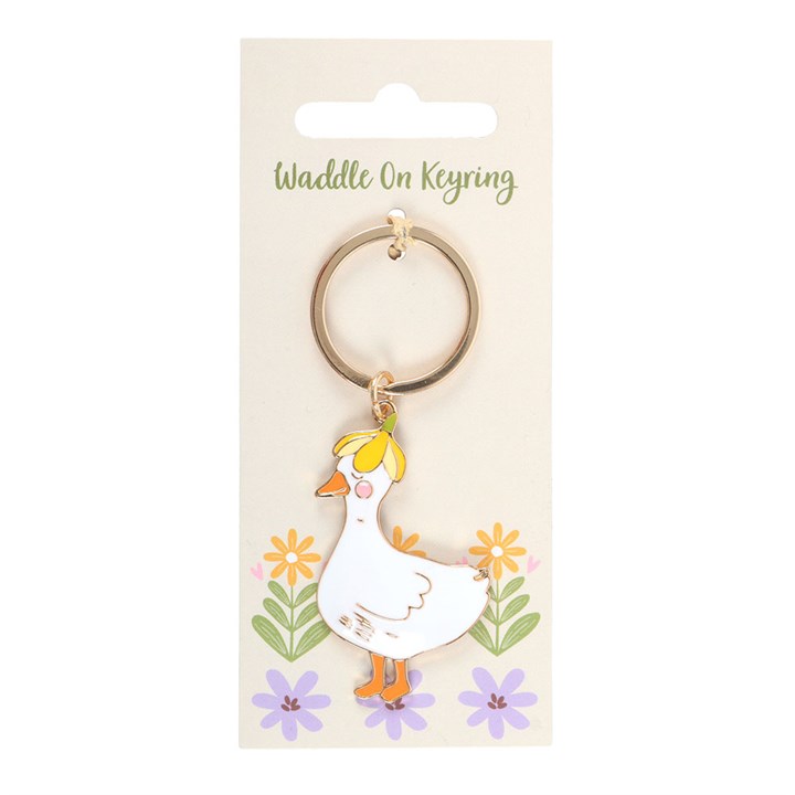 Keychain with a duck design on a beige card with floral elements