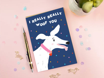 Card with a dog illustration and text 'I Really Really Woof You' on a pink background