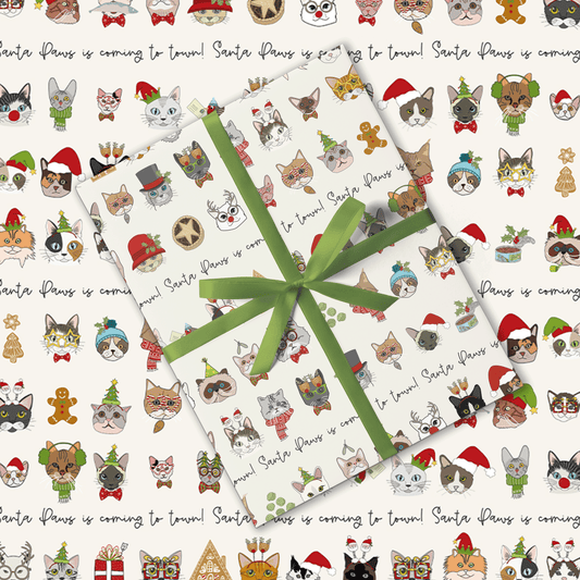 Gift wrap with Christmas-themed cat illustrations and a green ribbon.