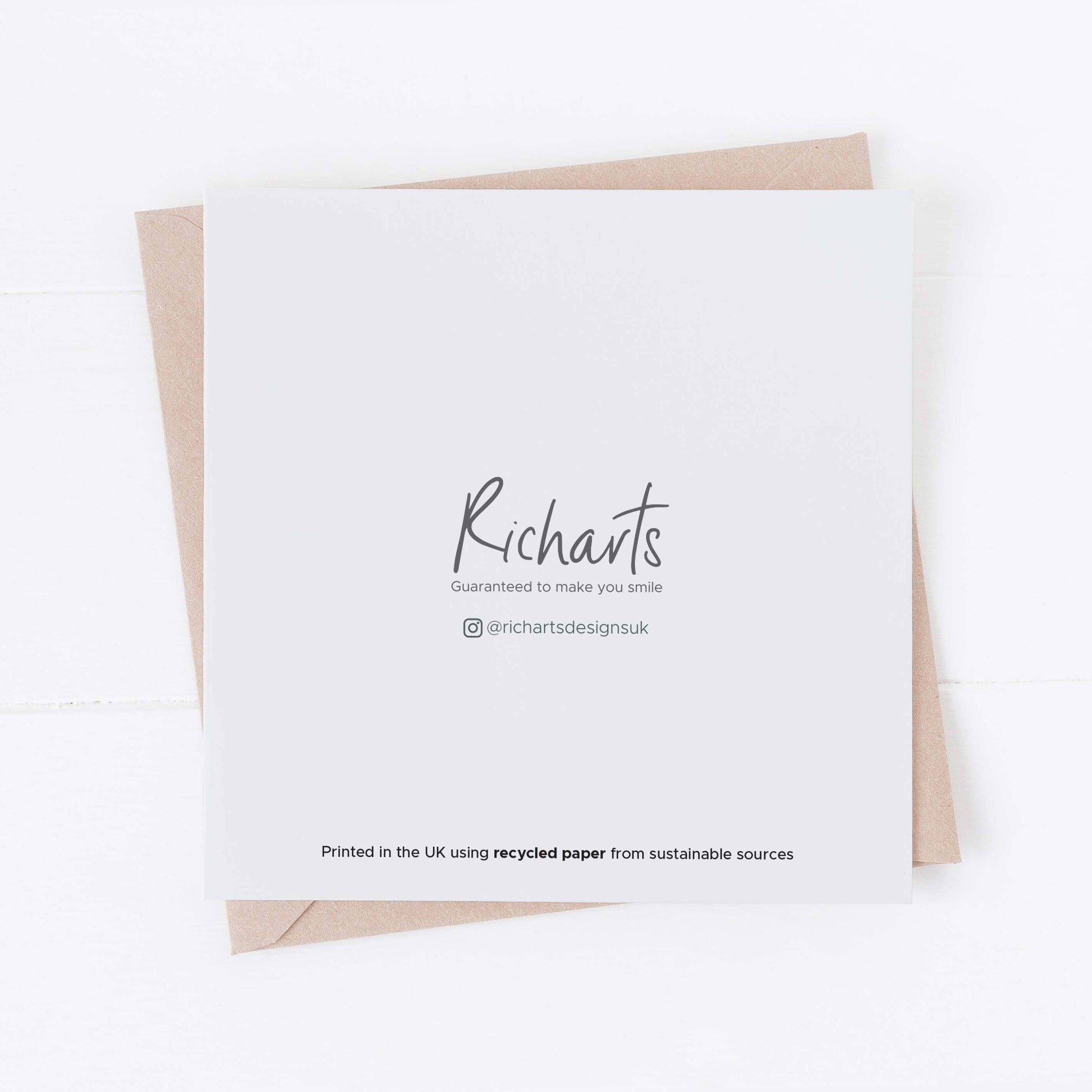 White card with 'Richarts Design' printed on it, featuring a brown envelope on a white background.
