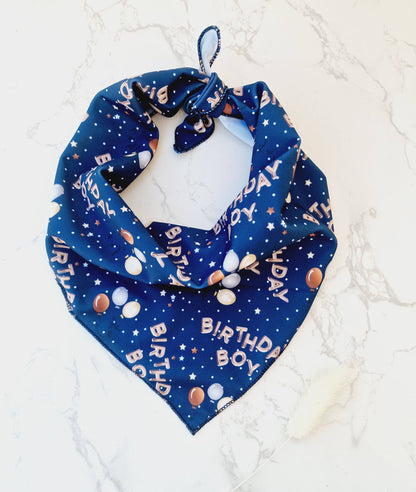 Blue bandana with birthday-themed print on a white background