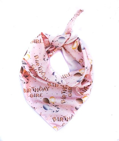 Pink dog bandana with 'Birthday Girl' text and birthday-themed designs on a white background