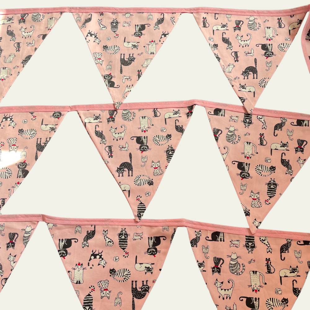 Triangle-shaped bunting flags with cat pattern on a pink background