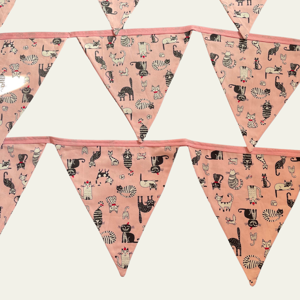 Triangle-shaped flags with cat pattern on a pink background