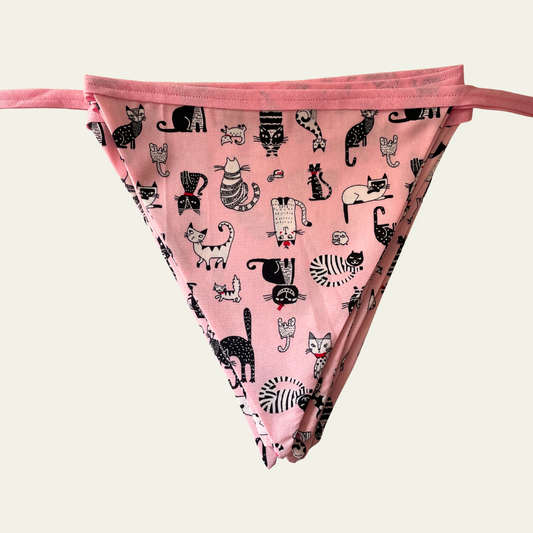 Pink bunting with black cat pattern on a light grey background
