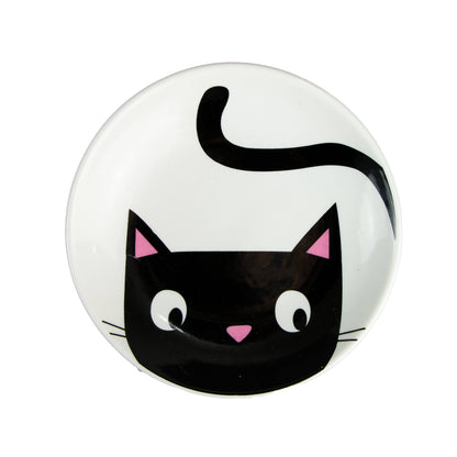 Round black and white dish with at design on a white background
