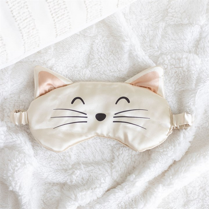 Cat-shaped sleep mask on a soft white background