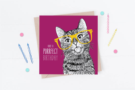 Greeting card with a cat illustration wearing glasses and text 'Have a purrfect birthday' on a pink background.