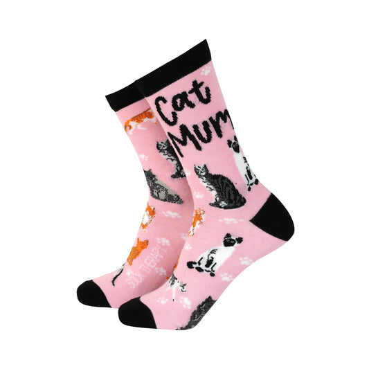 A pair of pink bamboo socks with a 'Cat Mum' text and various cat prints in black and orange.