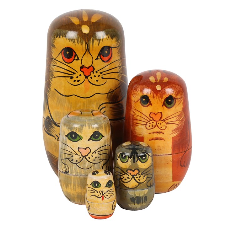 Set of wooden nesting dolls with cat designs on a white background