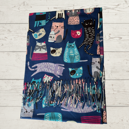 a navy blue scarf with images of cats in different colours, laid on a wooden surface.