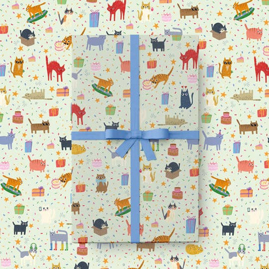 Gift box with a blue ribbon on a patterned cat themed background