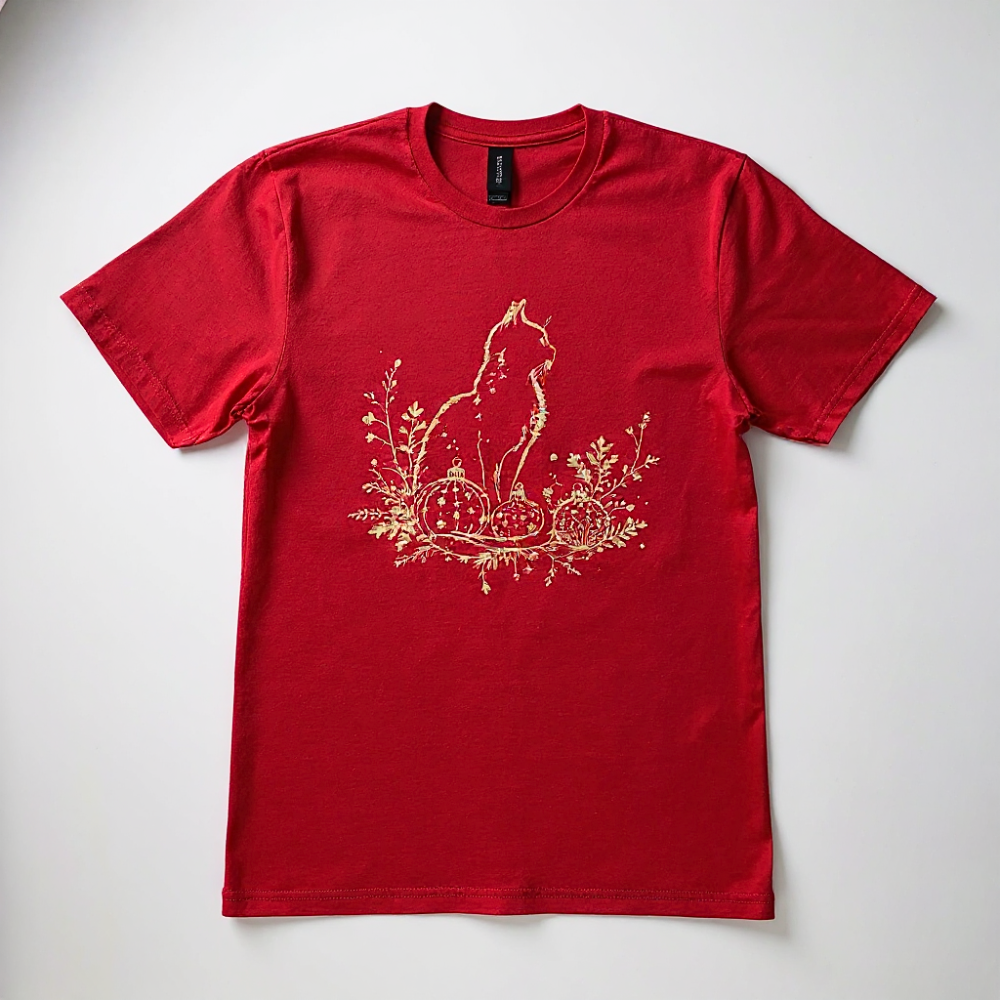 Red t-shirt with a gold cat and christmas design on a white background