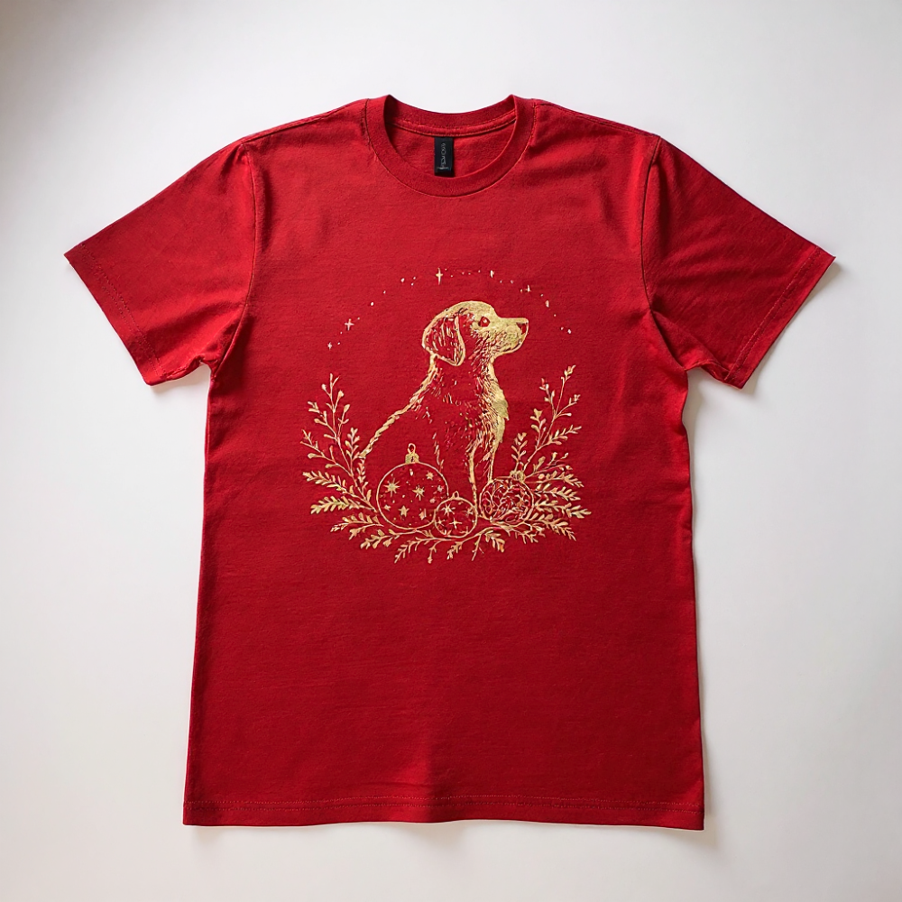 Red t-shirt with a gold dog and ornament design on a white background