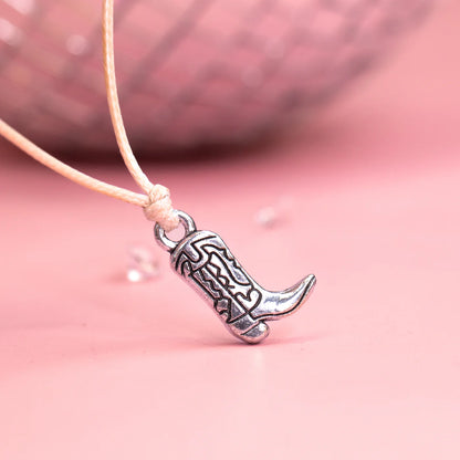 Close up shot of a bracelet with a cowgirl boot stainless steel charm. 