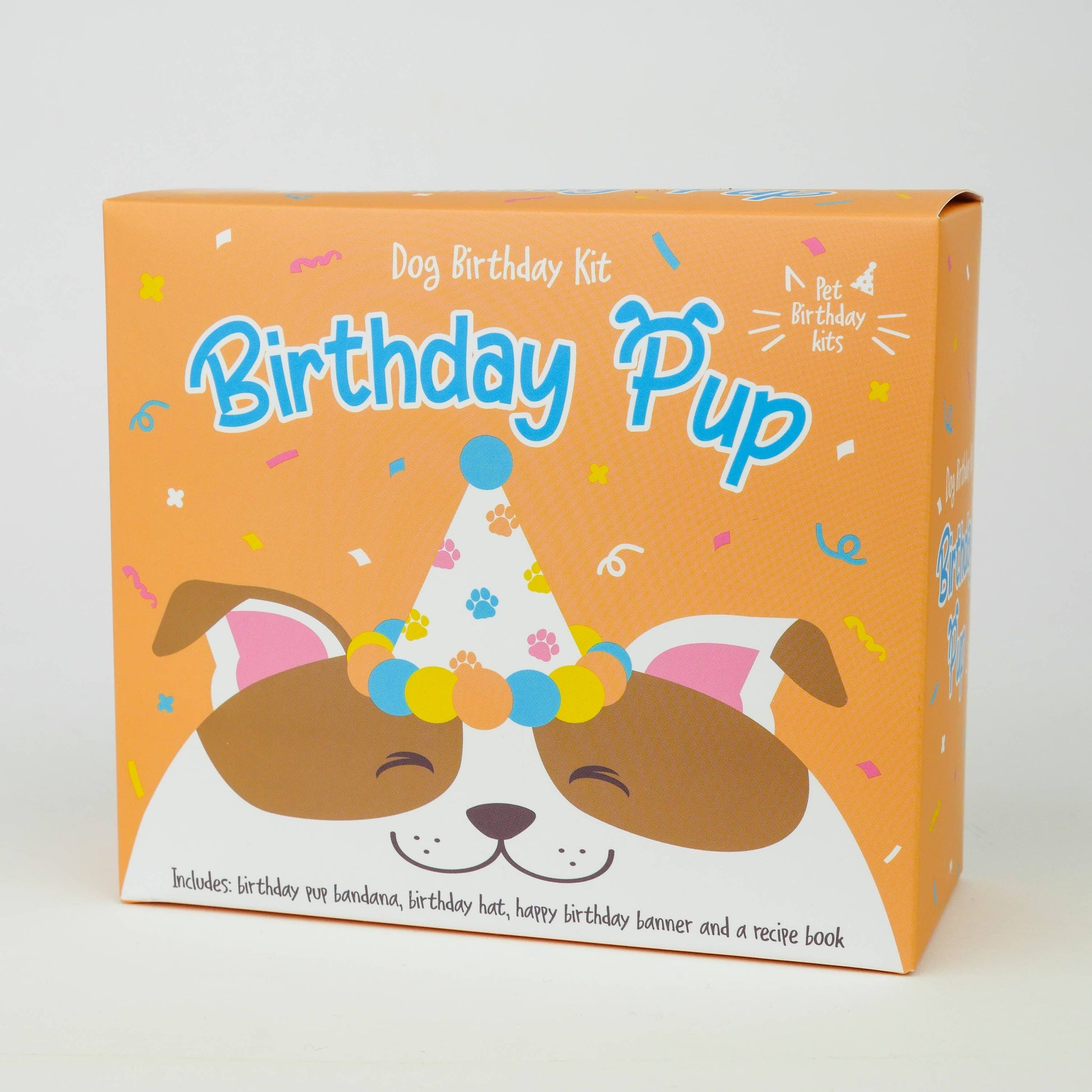 An orange box showing a dog birthday kit with a dog on the front smiling with a party hat on. 