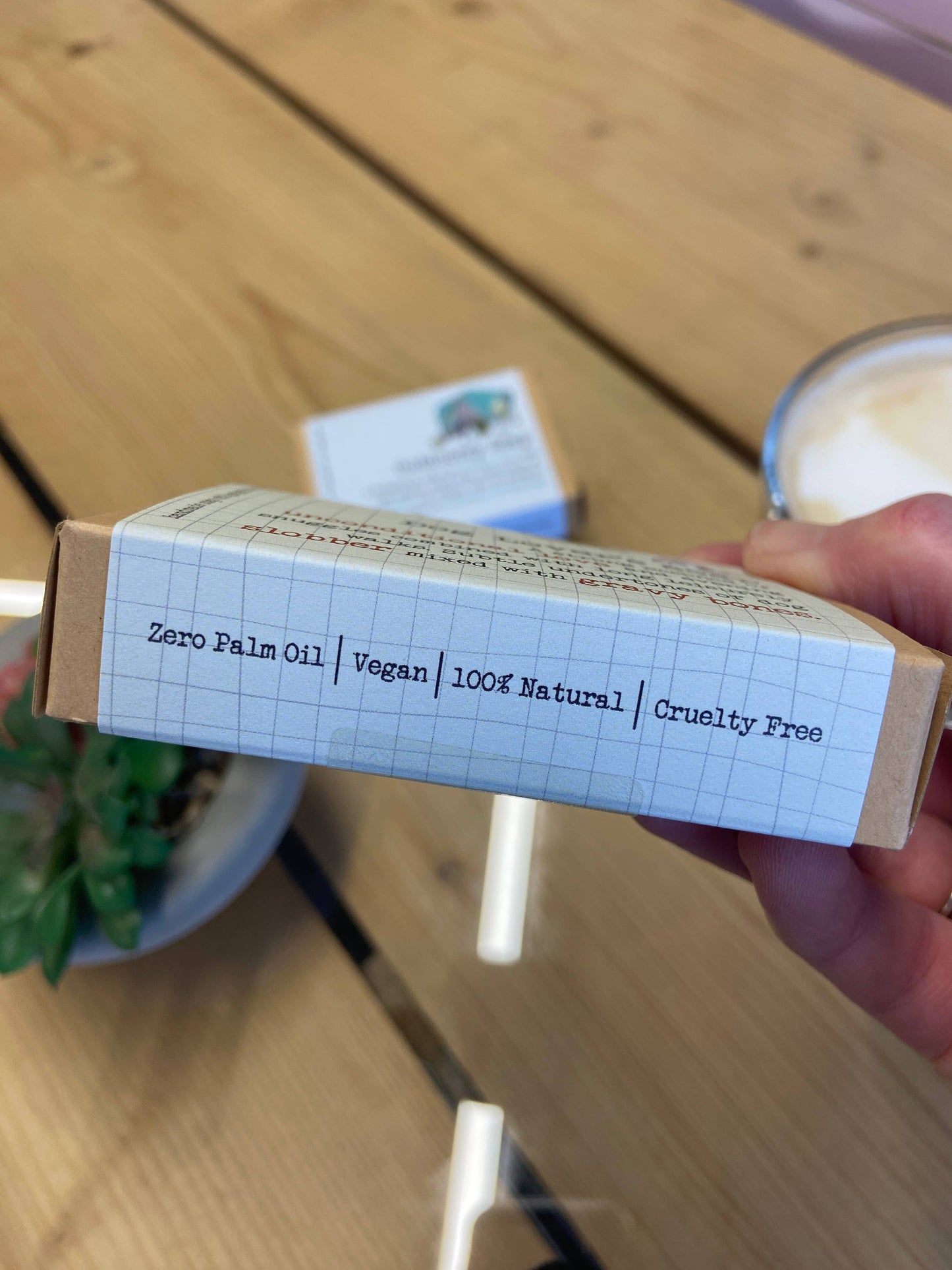 Product packaging with text on a wooden surface