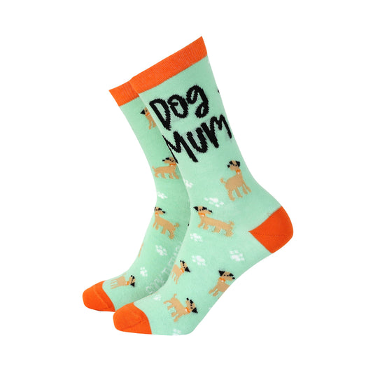 A pair of green bamboo socks with the text 'Dog Mum' and small dog illustrations, with orange accents on the cuffs.