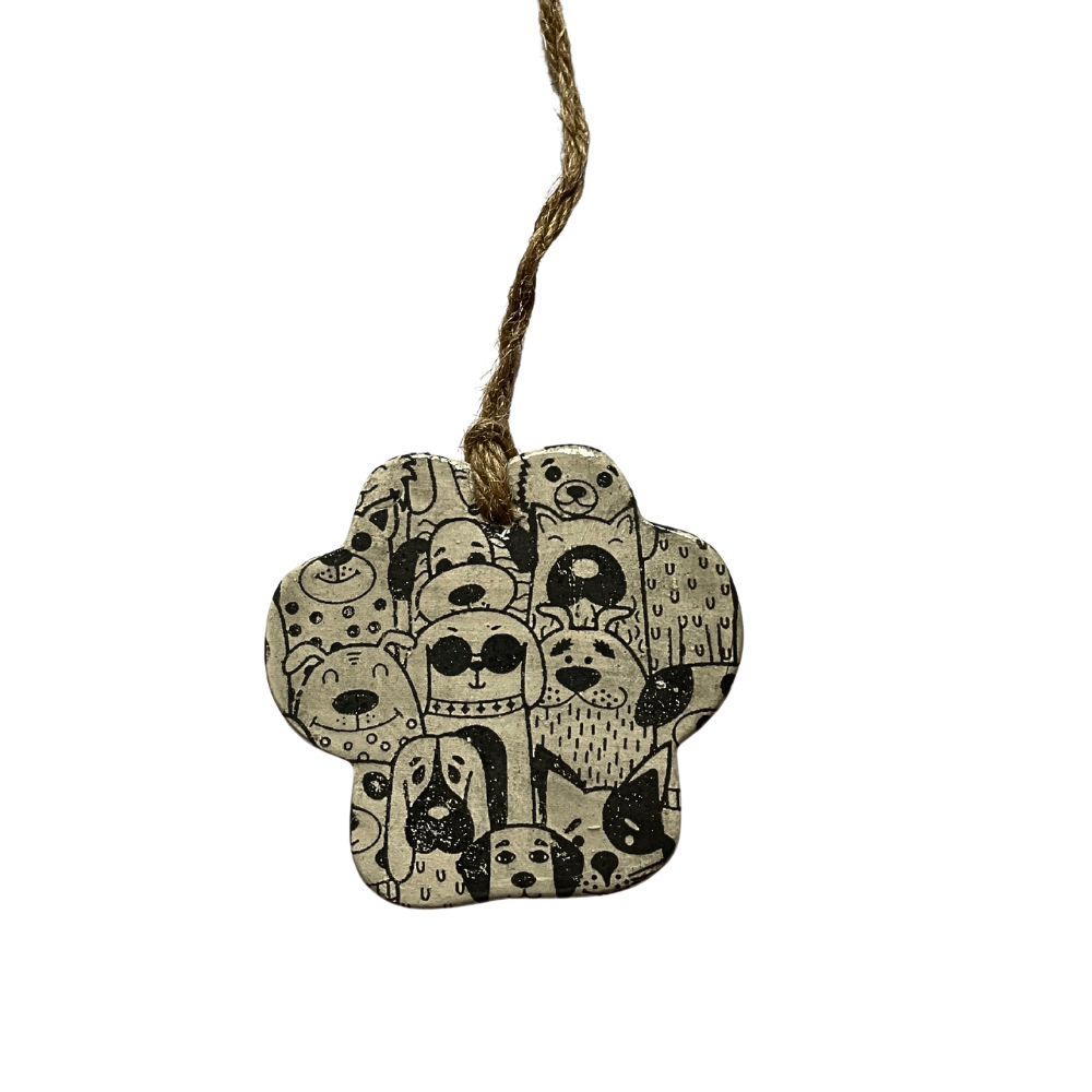 Decorative ceramic paw print with black dog illustrations on a white background