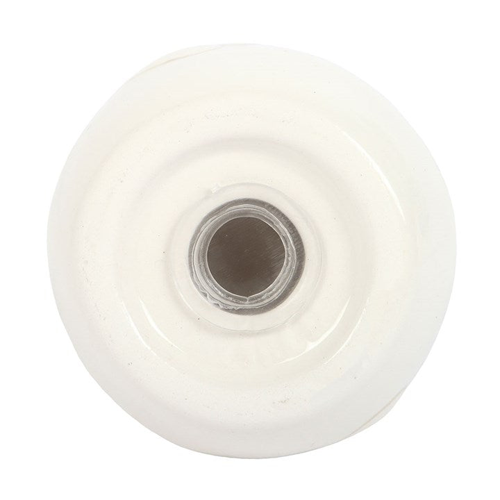 Bottom of a salt and pepper shaker showing the opening 