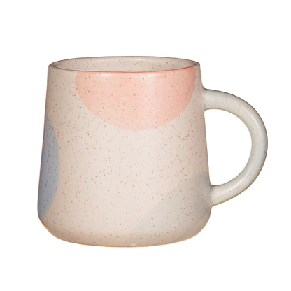 The back of a ceramic mug with colourful circle designs.