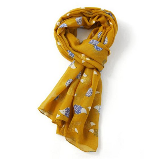 a mustard yellow coloured scarf with hedgehog print tied. 