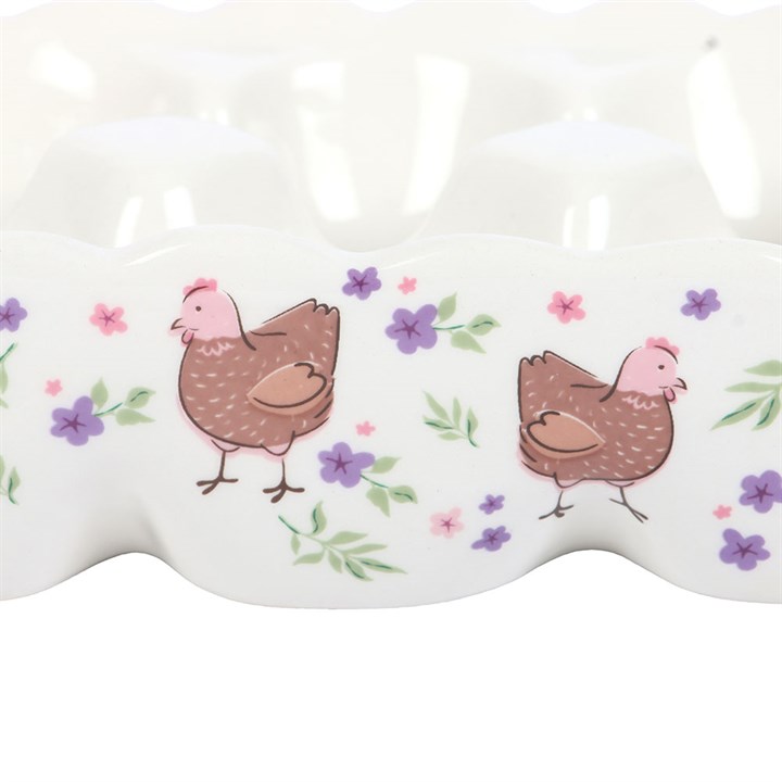 Close up showing the hen and floral design on an egg holder. 