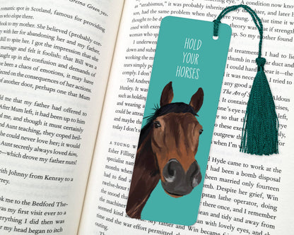 Bookmark with horse illustration and text 'Hold Your Horses' on an open book