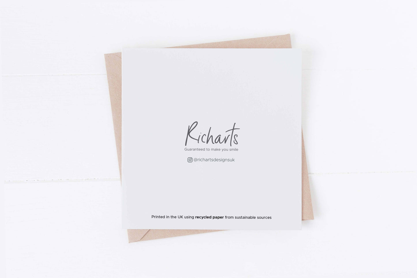 White card with 'Richarts' printed on it, featuring a brown envelope on a white background.