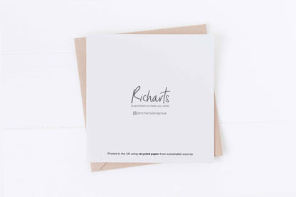 White card with 'Richarts' printed on it, featuring a brown envelope on a white background.