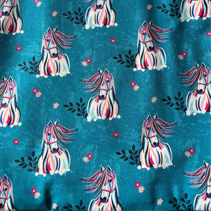 Pattern of colorful horses on a blue background