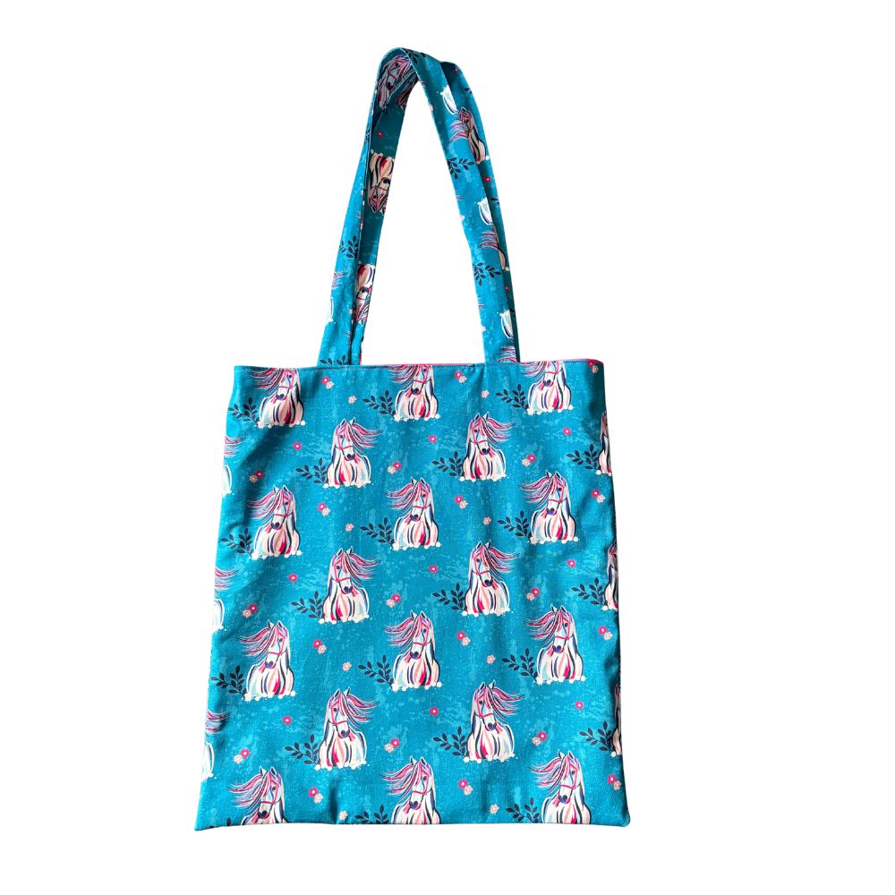Blue tote bag with horse pattern on a white background