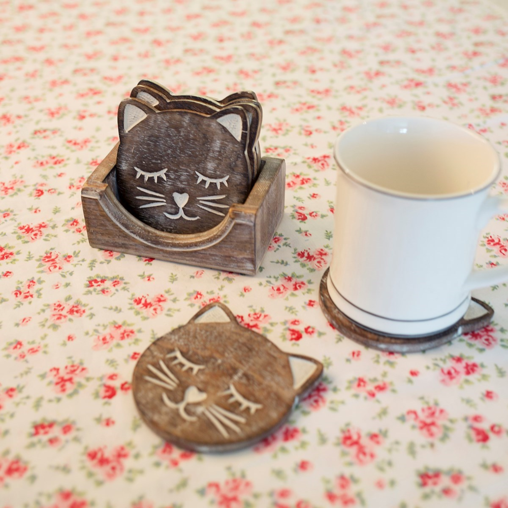 Cat coaster set with a mug on one of the coasters.